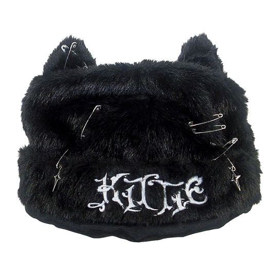 The Kittie Logo - Custom Cat Ears Beanie is a furry black winter hat featuring plush cat ears, decorated with safety pins and charms, and embroidered with the word "KITTIE" in white gothic-style lettering on the front.
